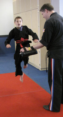 Zach high kicks to earn his second red belt.