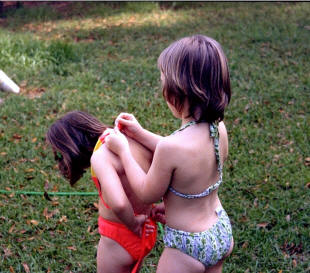 Karen allows Dottie to help tie her bathing suit.