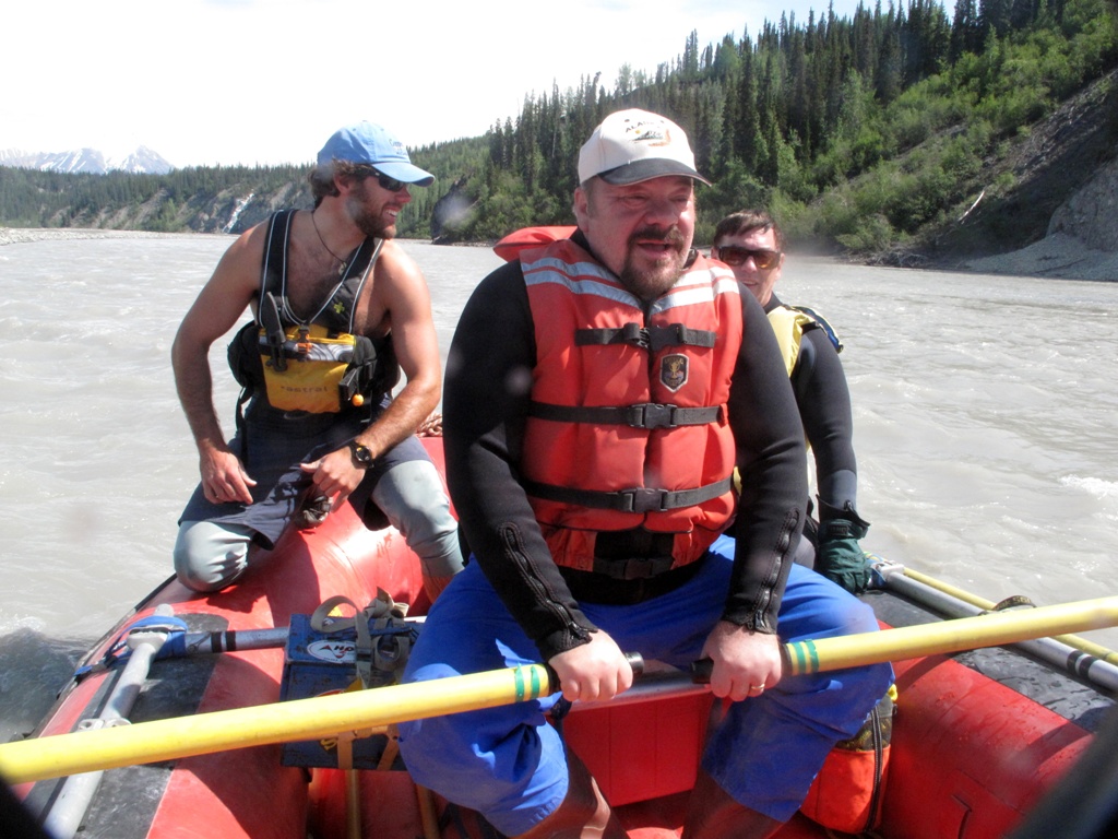 Jules and Michael observe as Paul rows on the Nizina River, Alaska.