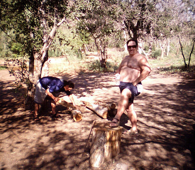 Eddie saws cottonwood trunks while Michael poses.